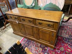 A reproduction 18th century style oak low dresser, fitted three drawers over three cupboards, length