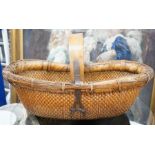 A brass mounted Chinese wicker trug basket. 67cm long