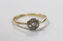 An 18ct and diamond cluster ring, size L/M, gross weight 1.4 grams.