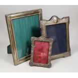 An Edwardian repousse silver mounted photograph frame, Birmingham, 1901, 19cm and two larger