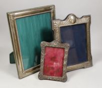 An Edwardian repousse silver mounted photograph frame, Birmingham, 1901, 19cm and two larger