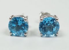 A modern pair of white metal (stamped 18) and single stone blue topaz set ear studs, 7mm, gross