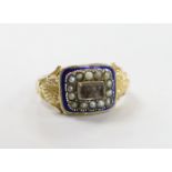 A 19th century yellow metal, enamel, seed pearl and plaited hair set mourning ring, with shell