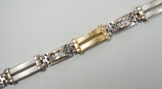 A modern two colour 585 and twelve stone diamond set bracelet, 17.75cm, gross weight 19.2 grams.