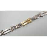 A modern two colour 585 and twelve stone diamond set bracelet, 17.75cm, gross weight 19.2 grams.