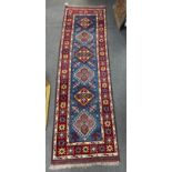 A Caucasian design blue ground runner, 220 x 66cm