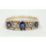 A modern Victorian style 9ct gold, three stone sapphire and two stone diamond set half hoop ring,