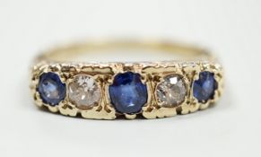 A modern Victorian style 9ct gold, three stone sapphire and two stone diamond set half hoop ring,