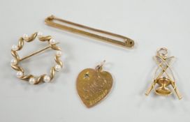 An Edwardian 9ct gold heart pendant (stone missing), 18mm, a yellow metal diablo charm and two