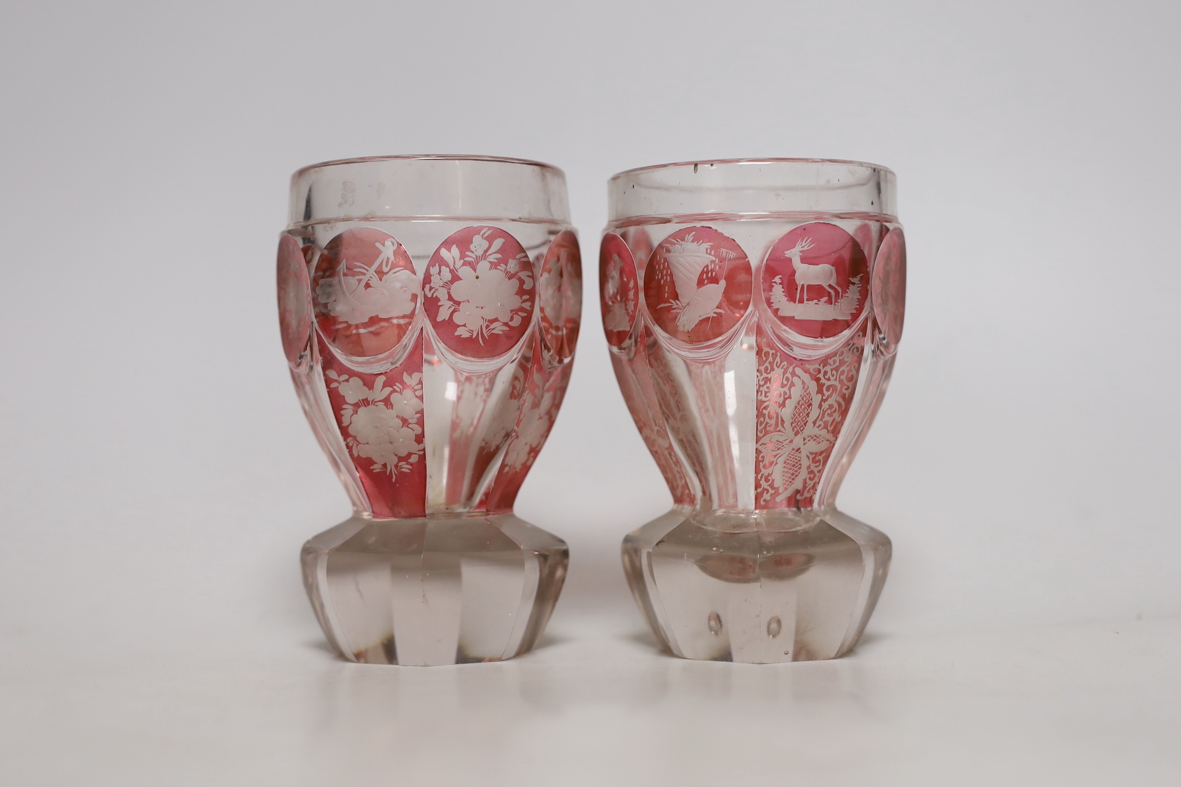 A pair of late 19th century Bohemian wheel engraved ruby stained glass beakers, 13.5cms high - Image 2 of 4