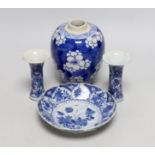 A Chinese blue and white prunus jar, two miniature vases and a dish, all Kangxi period, jar 14cms