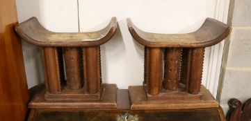 A pair of African carved hardwood stools, width 46cm, depth 29cm, height 43cm