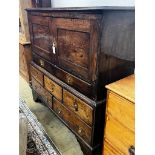 An 18th century oak low press cupboard, length 136cm, depth 53cm, height 137cm