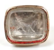 A 19th century gold plated and rock crystal? set fob seal, the matrix carved with hunting dog