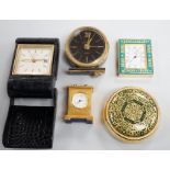 A Halcyon Days Harrods paperweight, a Halcyon Days timepiece and three other timepieces