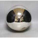 A large silver coloured witch’s ball