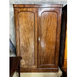 A Victorian mahogany wardrobe, enclosed by a pair of arched panelled full length doors, width 132cm,