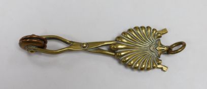 A brass skirt hem lifter. 14cm long