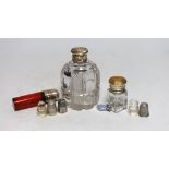Three silver or white metal mounted glass scent bottles including enamelled, 56mm and ruby glass,