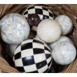 A basket of mother of pearl or bone veneered balls and other decorative balls