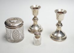 A pair of 1930's silver mounted dwarf candlesticks, 10cm, a silver mounted glass hair tidy and a