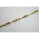 An 18k yellow metal fancy link bracelet with 14k clasp, 21cm, 10.7 grams.