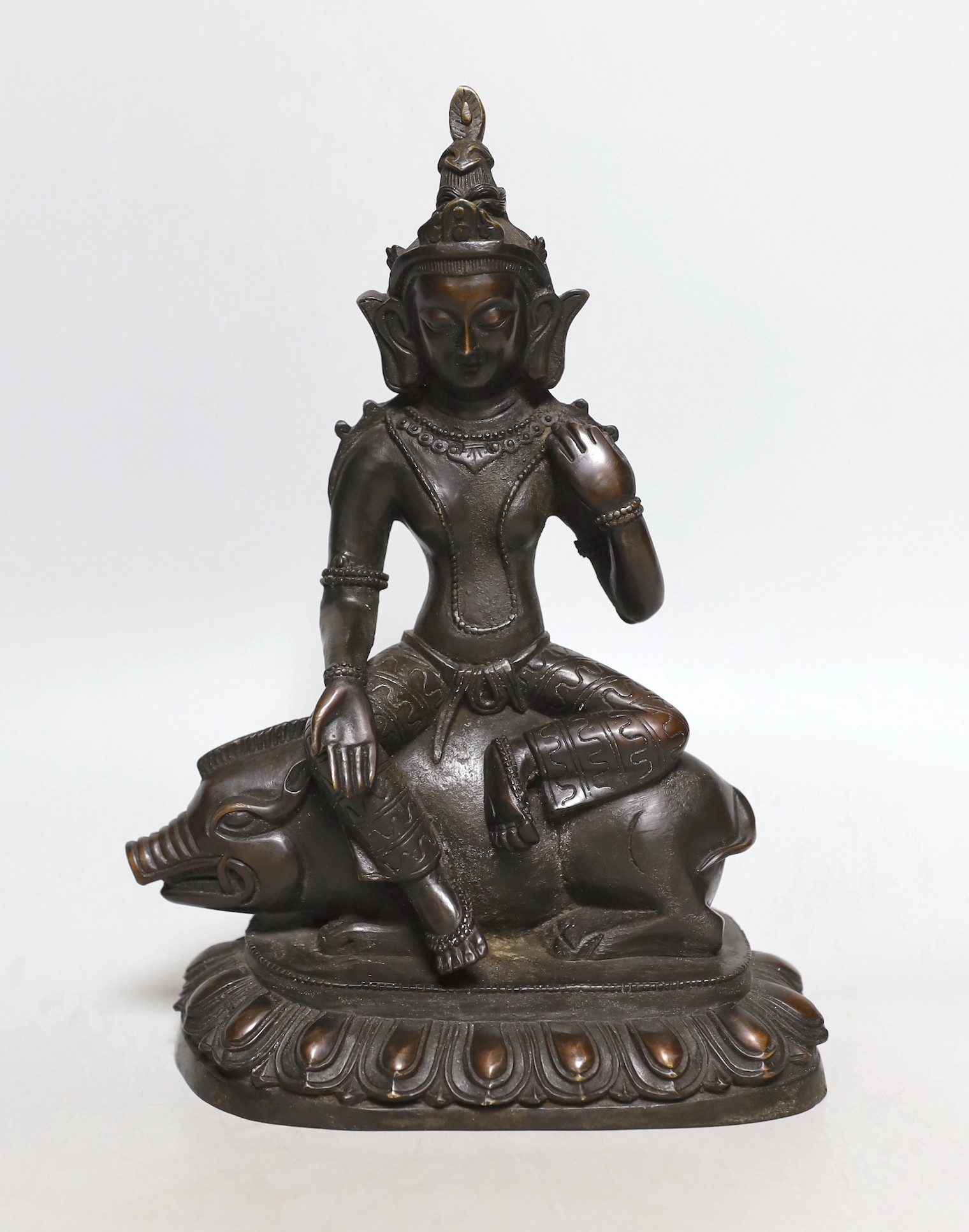 A buddhist bronze figure of Marici seated on a boar, 26cms high