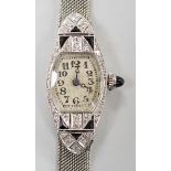An Art Deco white metal (stamped platine) black onyx and diamond cluster set cocktail watch, on a