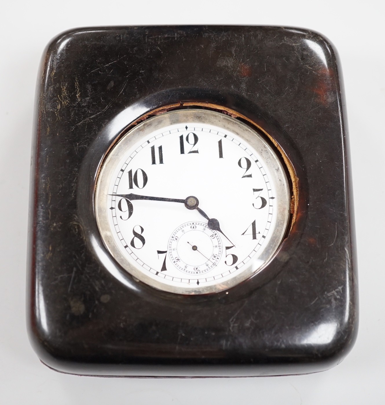 A tortoiseshell mounted travelling watch case, containing a Swiss white metal pocket watch, case