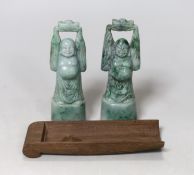 A pair of jadeite figural carvings and a gouged wood pan rest