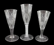 Three ‘hops and barley’ wheel engraved glass ale flutes, mid 18th century, the tallest with double