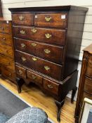 An 18th century oak chest on stand, width 99cm, depth 48cm, height 154cm