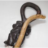 An African carved wood walking cane and a ‘dogs head’ walking cane