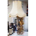A gilt composition putti table lamp. 86cm tall