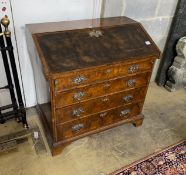 An 18th century walnut veneered bureau, adapted, fitted four graduating long drawers, width 97cm,