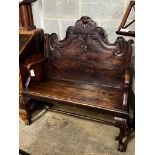 A Portuguese carved oak and fruitwood settle