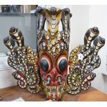 A large interesting Sri-Lankan painted wood Naga Raksha mask, early 20th century, 77cm tall