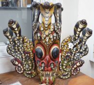 A large interesting Sri-Lankan painted wood Naga Raksha mask, early 20th century, 77cm tall