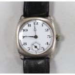 A gentleman's 1920's silver manual wind wrist watch, with Arabic dial and subsidiary seconds, on a