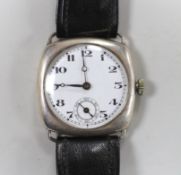 A gentleman's 1920's silver manual wind wrist watch, with Arabic dial and subsidiary seconds, on a