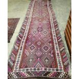 A polychrome Kilim flatweave runner, 434 x 124cm