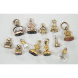 A collection of twelve small 19th century mainly yellow metal fob seals, with assorted matrices