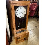 A vintage Gledhill-Brook oak cased clocking in machine, height 106cm