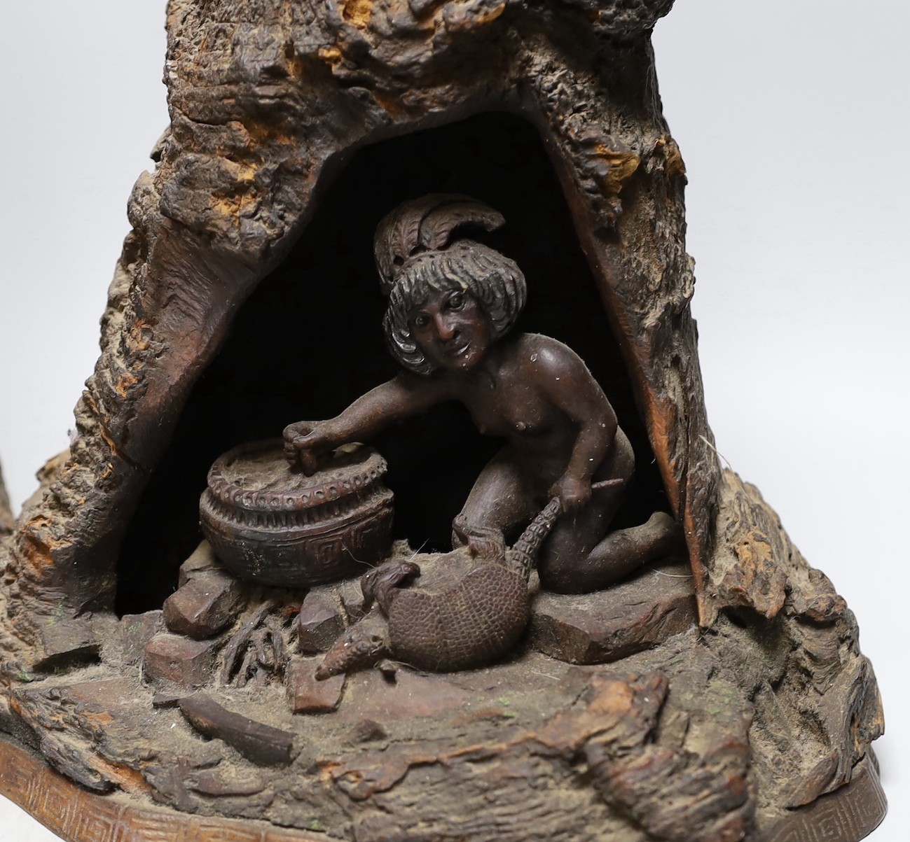 A wood carving of a bear climbing amongst rocks and a tree and another similar carving of figure - Image 2 of 4