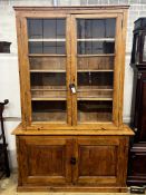 A 19th century French provincial pine two door glazed bookcase, length 151cm, depth 39cm, height