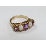 A modern 9ct gold, three stone amethyst and two stone white opal set half hoop ring, with white