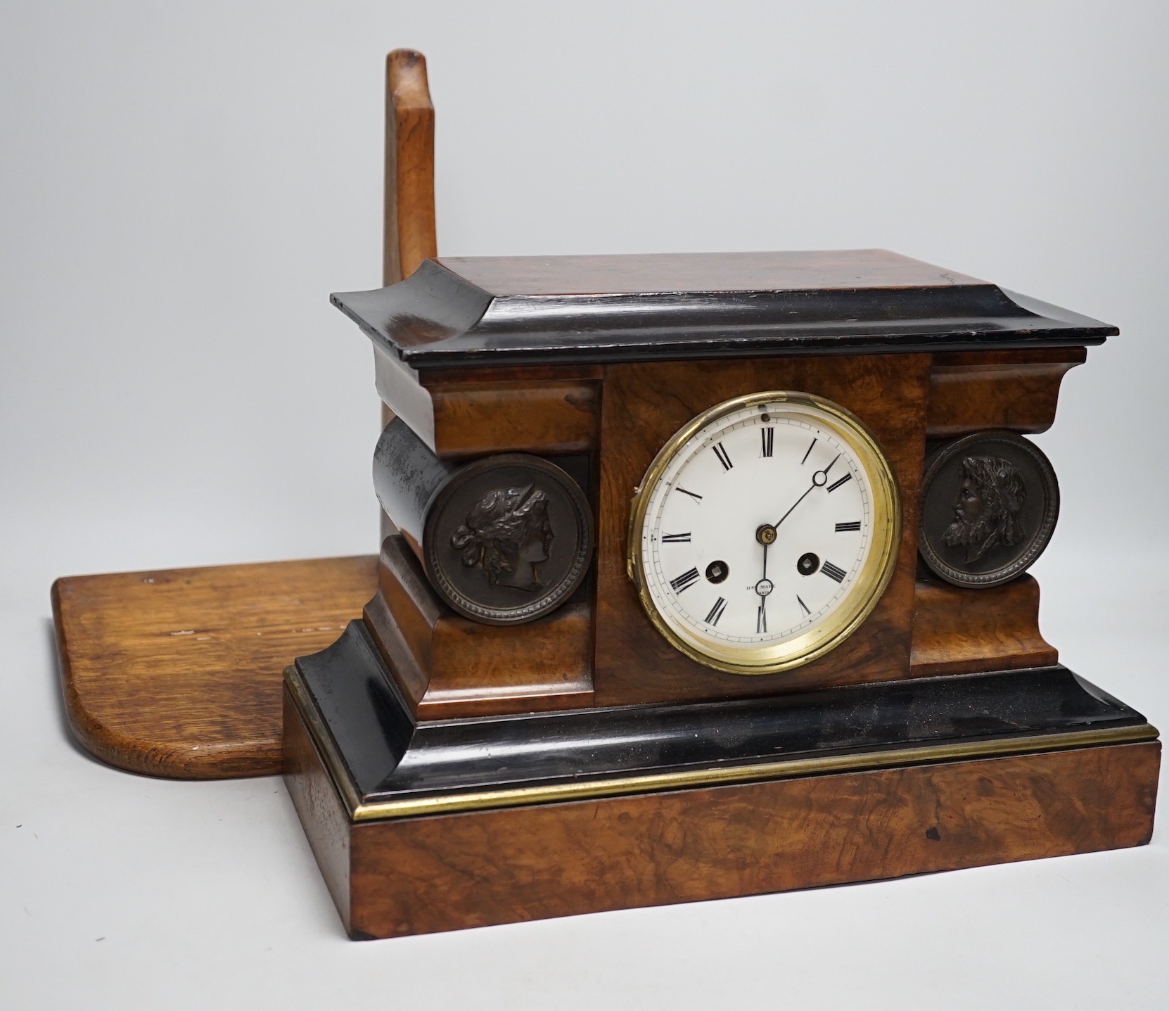 A Victorian walnut and ebonised bracket clock with two classical cartouches, 33cms wide x 23cms high