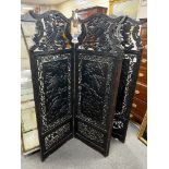 An early 20th century Japanese carved ebonised wood four fold dressing screen, width 56cm, height