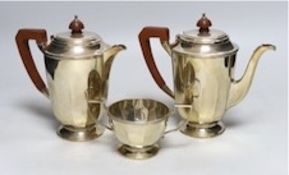 A George VI panelled silver coffee pot, hot water pot and sugar bowl by Mappin & Webb, Sheffield,