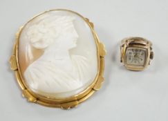 A pinchbeck mounted oval cameo shell brooch, 64mm and a gold plated watch ring.